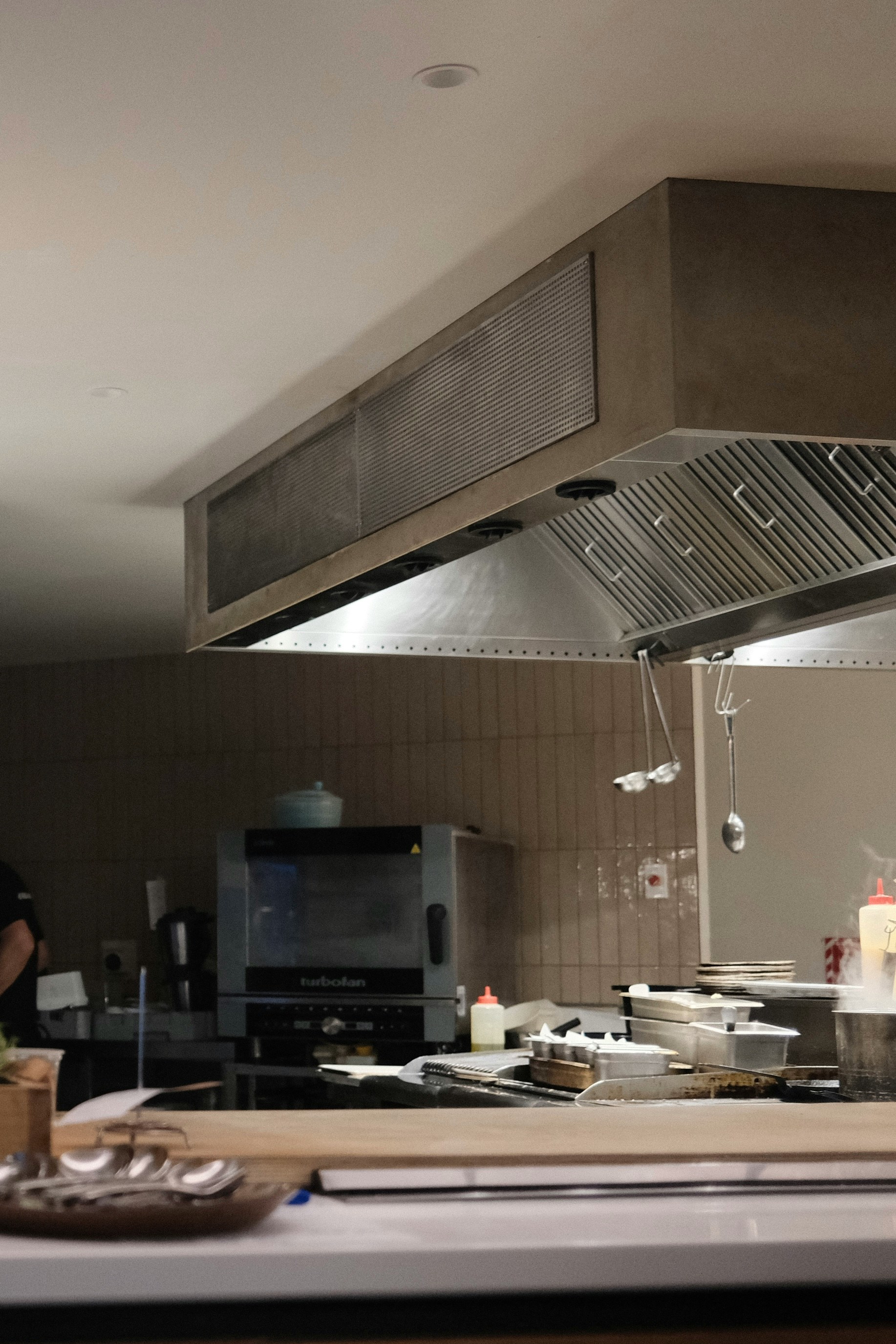 Fire suppression system above commercial range